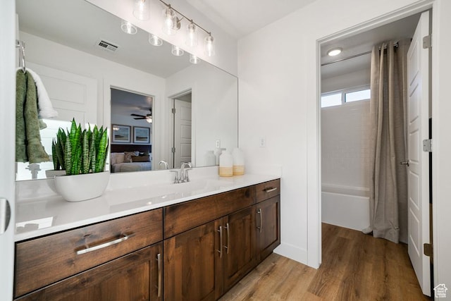 6068 S White Trails Dr, St George, UT 84790 - bathroom featuring vanity, wood finished floors, shower / bath combination with curtain, and a ceiling fan
