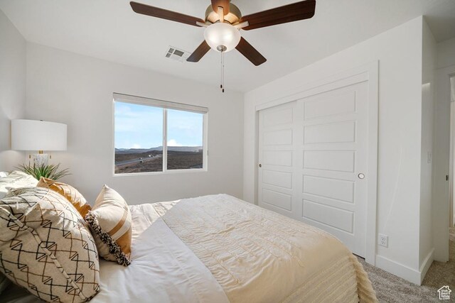 6068 S White Trails Dr, St George, UT 84790 - bedroom with carpet floors, a closet, a ceiling fan, and baseboards