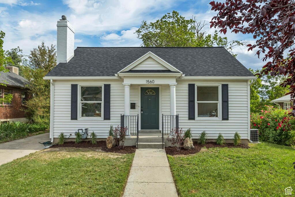 1560 E Downington Ave S, Salt Lake City, UT 84105 - bungalow-style home featuring a front lawn, a chimney, and a shingled roof