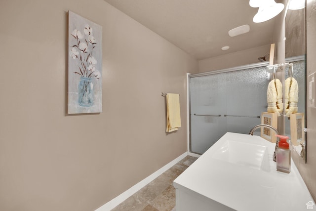 5945 N Spring St, Stansbury Park, UT 84074 - bathroom featuring an enclosed shower, vanity, and baseboards