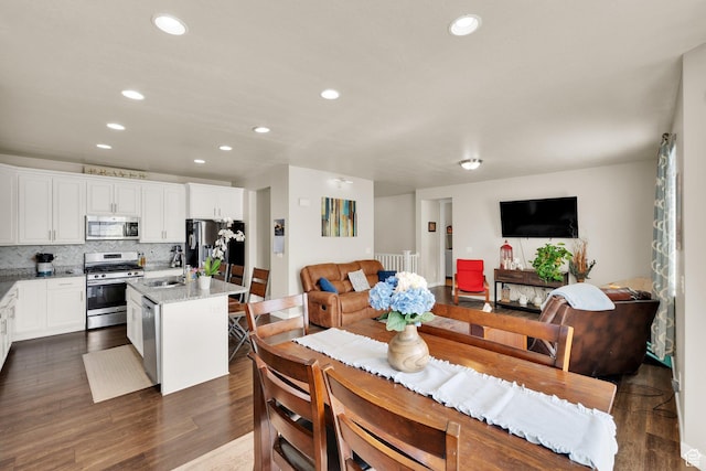 5945 N Spring St, Stansbury Park, UT 84074 - dining area with recessed lighting and dark wood-style floors