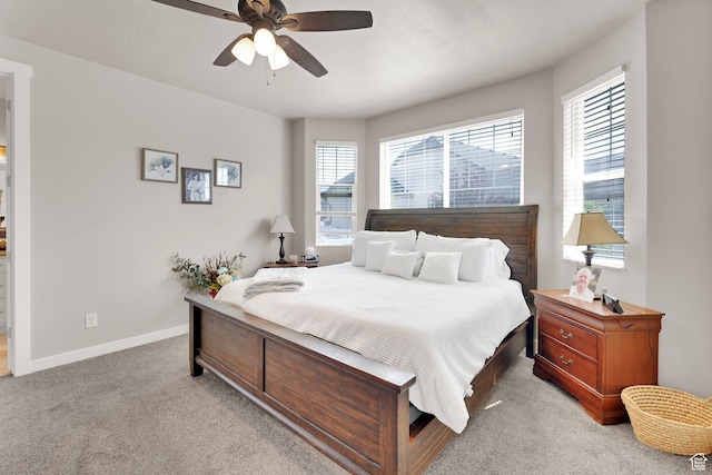 5945 N Spring St, Stansbury Park, UT 84074 - bedroom with multiple windows, light carpet, baseboards, and ceiling fan