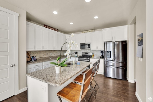 5945 N Spring St, Stansbury Park, UT 84074 - kitchen with appliances with stainless steel finishes, backsplash, white cabinets, baseboards, and recessed lighting