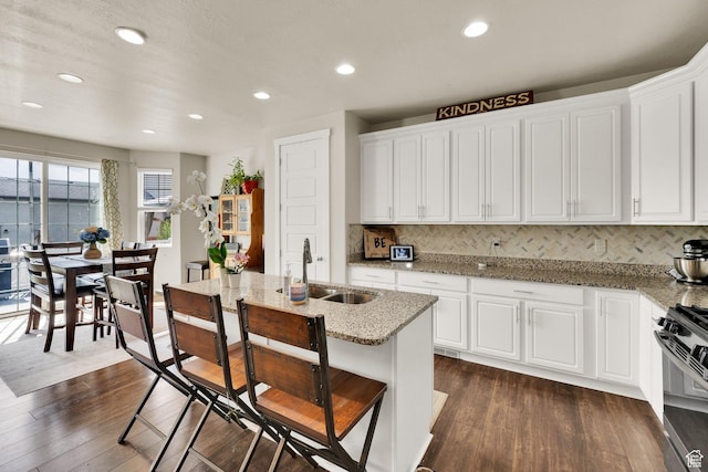 5945 N Spring St, Stansbury Park, UT 84074 - kitchen with dark wood-style flooring, gas range, tasteful backsplash, and recessed lighting