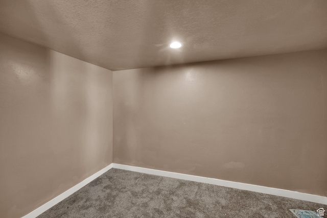 5945 N Spring St, Stansbury Park, UT 84074 - spare room with dark colored carpet, baseboards, a textured ceiling, and recessed lighting