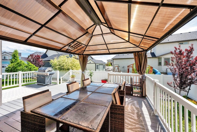 5945 N Spring St, Stansbury Park, UT 84074 - wooden deck with outdoor dining space, a residential view, grilling area, and a gazebo