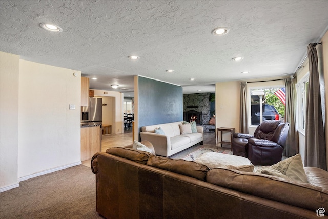 1225 E 5th St, Ogden, UT 84404 - living room featuring a textured ceiling, light colored carpet, recessed lighting, baseboards, and a stone fireplace