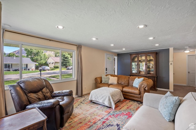 1225 E 5th St, Ogden, UT 84404 - living room featuring baseboards, recessed lighting, a textured ceiling, and light colored carpet