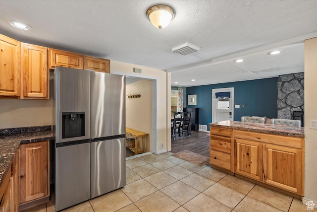 1225 E 5th St, Ogden, UT 84404 - kitchen featuring stainless steel refrigerator with ice dispenser, dark countertops, light tile patterned flooring, a textured ceiling, and recessed lighting