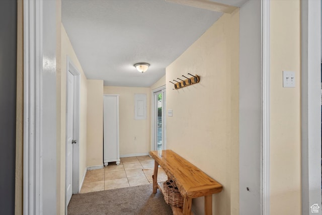 1225 E 5th St, Ogden, UT 84404 - hallway featuring light tile patterned floors, light colored carpet, and baseboards