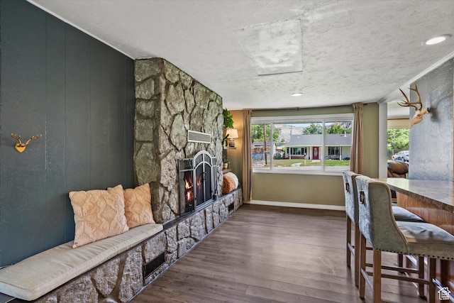 1225 E 5th St, Ogden, UT 84404 - dining room with a stone fireplace, wood finished floors, and baseboards