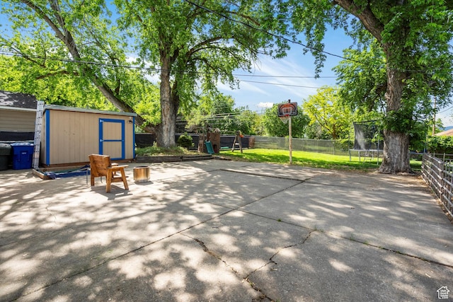 1225 E 5th St, Ogden, UT 84404 - fenced backyard featuring a trampoline and a patio