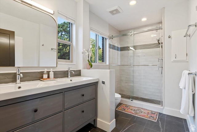 785 E Tenth Ave N, Salt Lake City, UT 84103 - bathroom featuring double vanity, a stall shower, toilet, tile patterned flooring, and recessed lighting