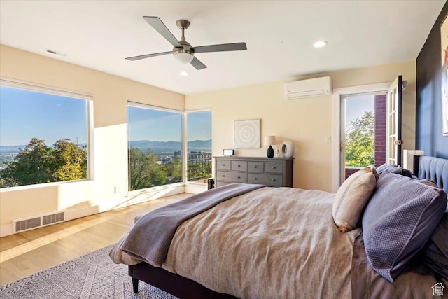 785 E Tenth Ave N, Salt Lake City, UT 84103 - bedroom with a wall mounted AC, wood finished floors, access to exterior, a ceiling fan, and recessed lighting