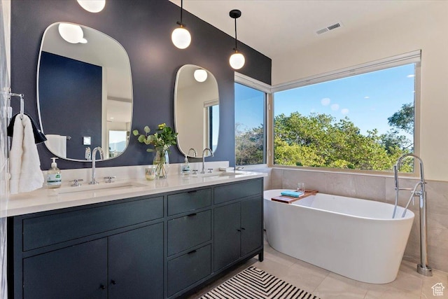 785 E Tenth Ave N, Salt Lake City, UT 84103 - full bath featuring tile walls, a freestanding tub, double vanity, tile patterned flooring, and wainscoting