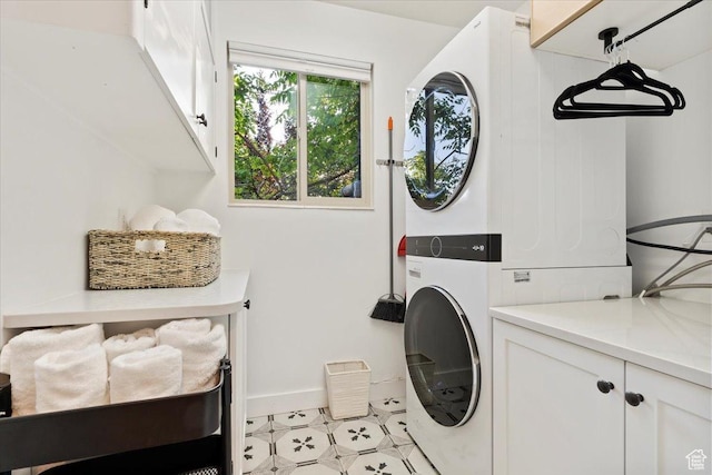 785 E Tenth Ave N, Salt Lake City, UT 84103 - washroom with stacked washing machine and dryer, cabinet space, baseboards, and light tile patterned flooring
