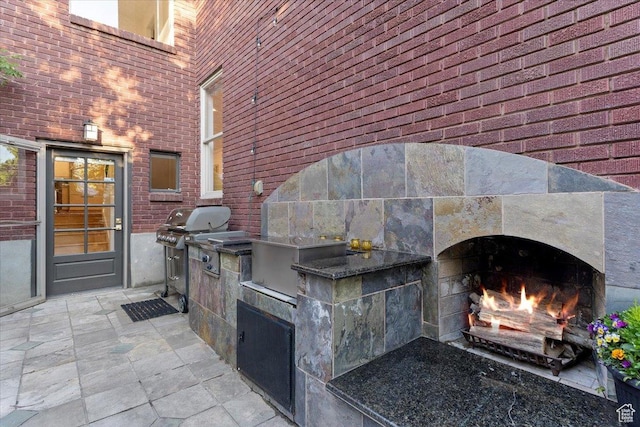 785 E Tenth Ave N, Salt Lake City, UT 84103 - view of patio with a warm lit fireplace