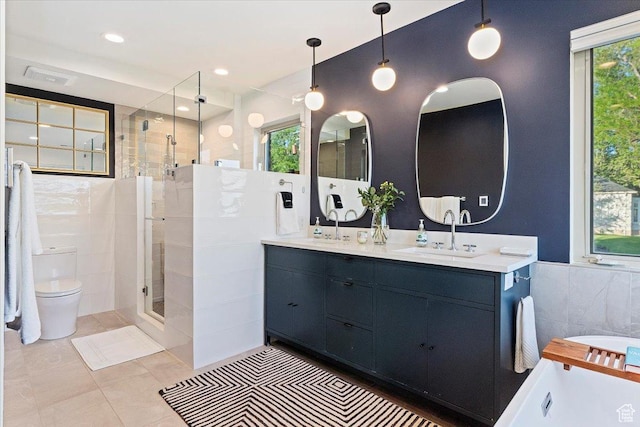 785 E Tenth Ave N, Salt Lake City, UT 84103 - bathroom featuring a shower stall, tile walls, double vanity, a tub, and toilet