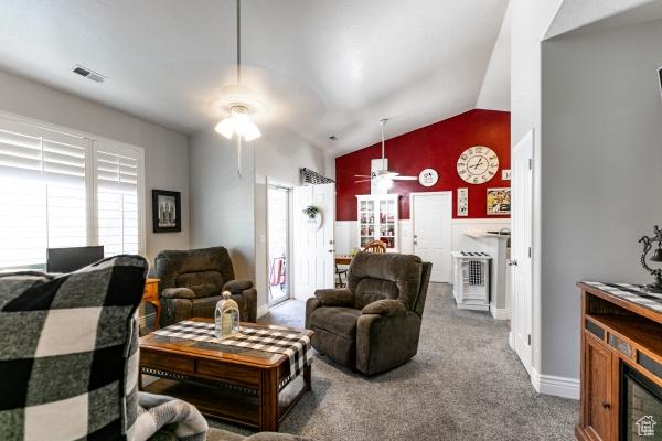 4732 W Wagon Train Dr, Herriman, UT 84096 - living room with a ceiling fan, vaulted ceiling, carpet, and baseboards