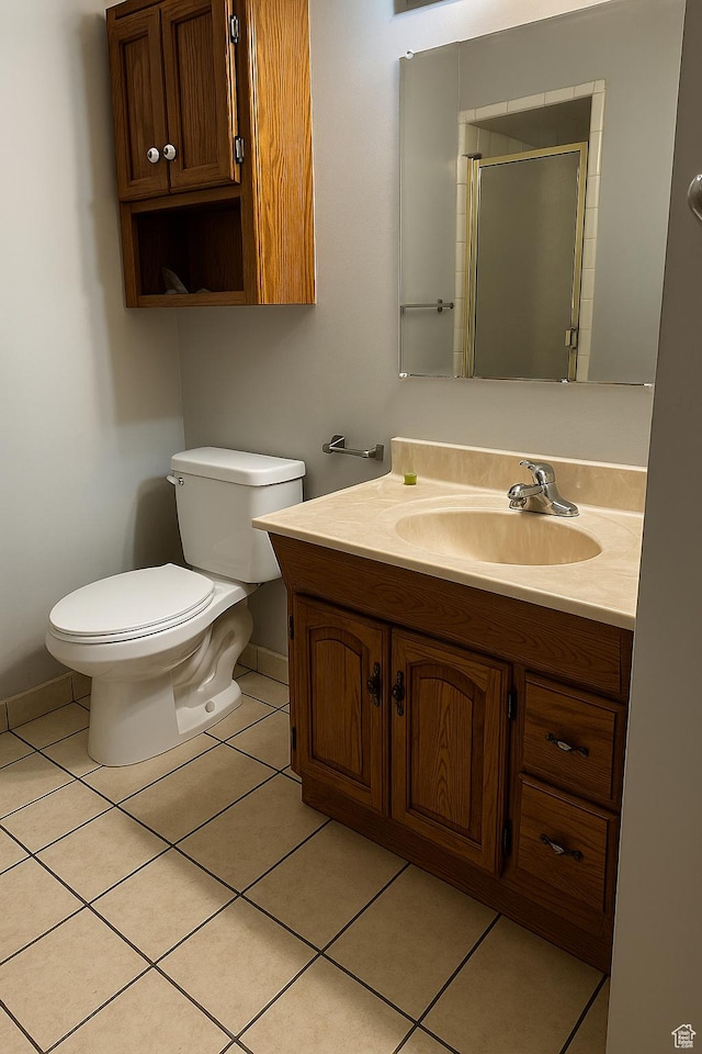 3291 S 4000 W, West Valley City, UT 84120 - bathroom featuring vanity, baseboards, tile patterned floors, toilet, and a shower with shower door