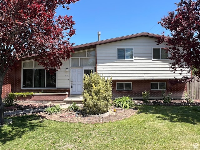 3291 S 4000 W, West Valley City, UT 84120 - back of house featuring a yard and brick siding