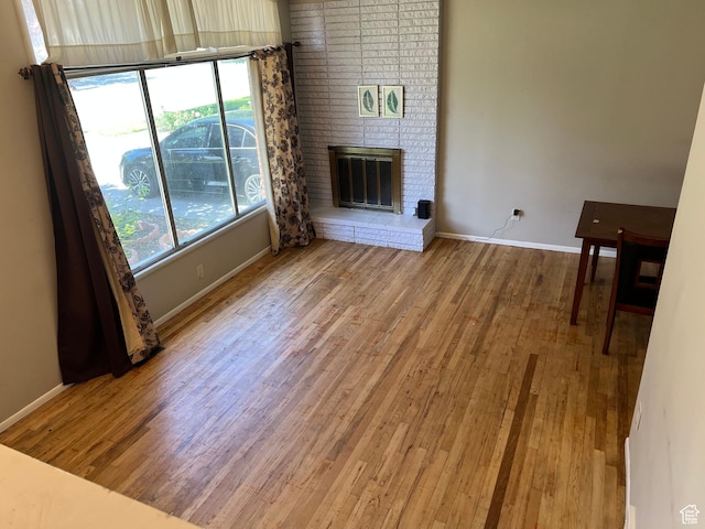 3291 S 4000 W, West Valley City, UT 84120 - unfurnished living room featuring wood finished floors, healthy amount of natural light, and baseboards
