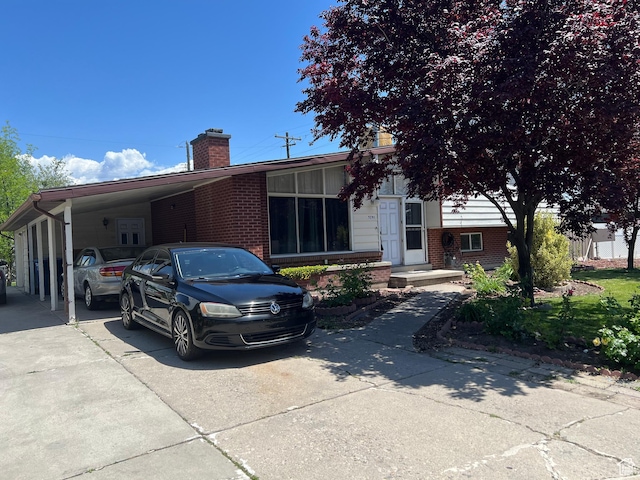 3291 S 4000 W, West Valley City, UT 84120 - view of front of property featuring a chimney, an attached carport, concrete driveway, and brick siding