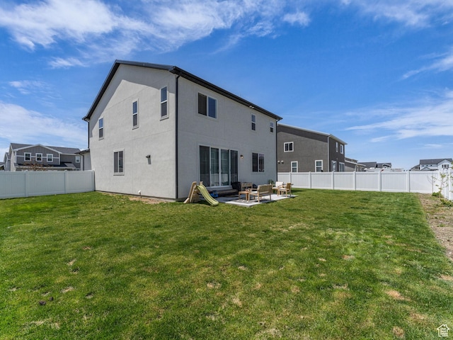 6352 N Canter Dr, Stansbury Park, UT 84074 - rear view of house featuring a patio, stucco siding, and an outdoor hangout area