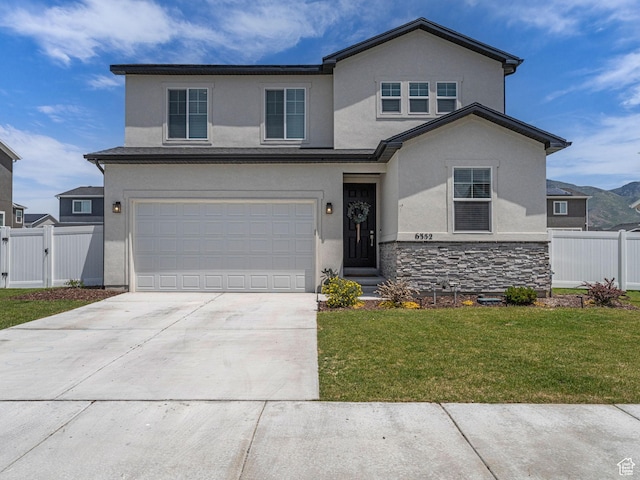 6352 N Canter Dr, Stansbury Park, UT 84074 - traditional-style house with stucco siding, an attached garage, and driveway