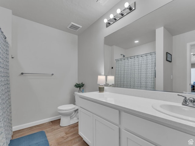6352 N Canter Dr, Stansbury Park, UT 84074 - bathroom with toilet, vanity, wood finished floors, and baseboards