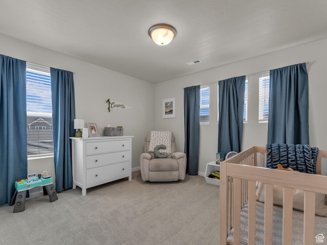6352 N Canter Dr, Stansbury Park, UT 84074 - bedroom featuring multiple windows, a crib, light carpet, and baseboards