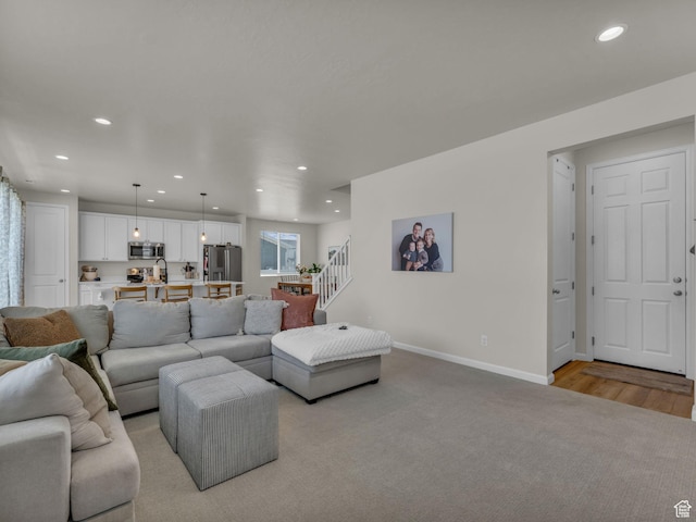 6352 N Canter Dr, Stansbury Park, UT 84074 - living area featuring recessed lighting, stairs, baseboards, and light carpet