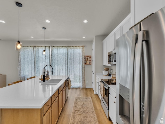 6352 N Canter Dr, Stansbury Park, UT 84074 - kitchen with stainless steel appliances, a sink, light wood-style flooring, recessed lighting, and light countertops