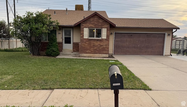 39 S 1300 W, Clearfield, UT 84015 - view of front of house with driveway, an attached garage, brick siding, and a shingled roof