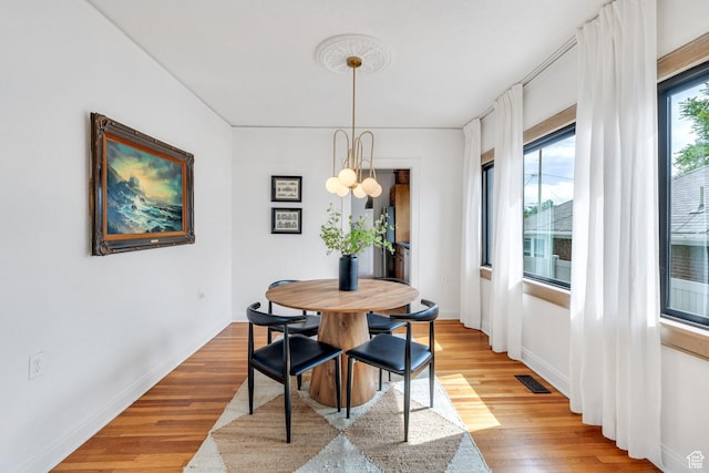 1440 E 1300 S, Salt Lake City, UT 84105 - dining space with light wood-style floors, a chandelier, and baseboards