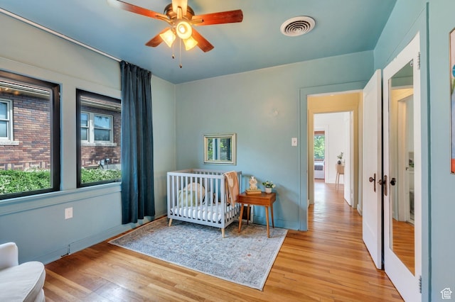 1440 E 1300 S, Salt Lake City, UT 84105 - bedroom featuring light wood-type flooring, baseboards, and a crib