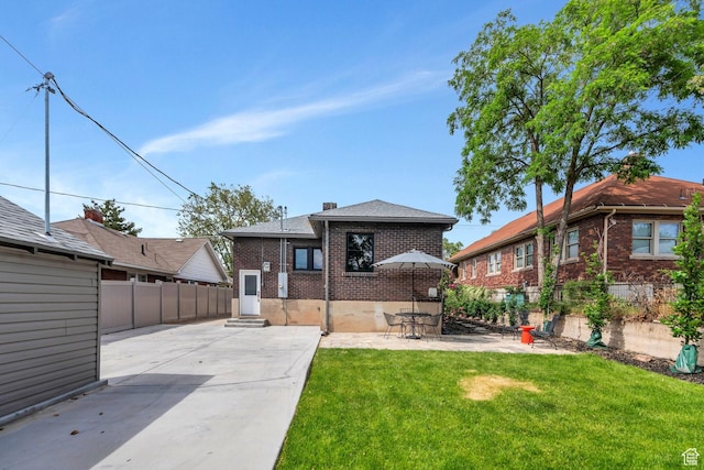 1440 E 1300 S, Salt Lake City, UT 84105 - back of house featuring brick siding, a patio area, and a chimney
