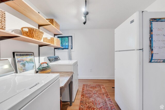 1440 E 1300 S, Salt Lake City, UT 84105 - washroom with washing machine and clothes dryer, light wood-style flooring, baseboards, and rail lighting