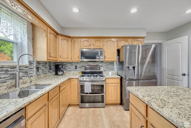 1254 W 2700 S, Syracuse, UT 84075 - kitchen with stainless steel appliances, a sink, light wood-type flooring, light stone countertops, and recessed lighting