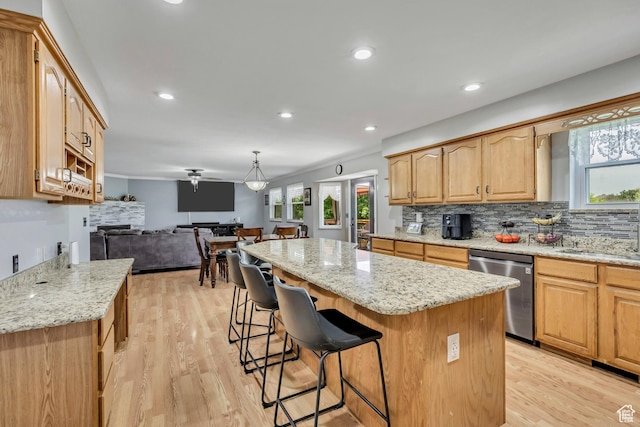 1254 W 2700 S, Syracuse, UT 84075 - kitchen featuring dishwasher, a kitchen island, open floor plan, a kitchen bar, and light stone counters