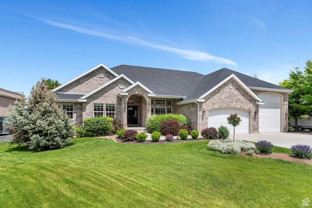 1736 S Range Rd, Saratoga Springs, UT 84045 - view of front facade featuring an attached garage, a front yard, brick siding, and concrete driveway