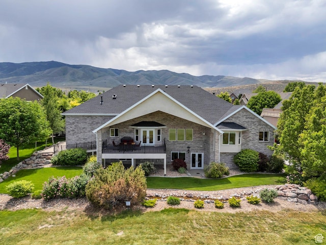 1736 S Range Rd, Saratoga Springs, UT 84045 - rear view of house with french doors, stone siding, a mountain view, a yard, and a shingled roof