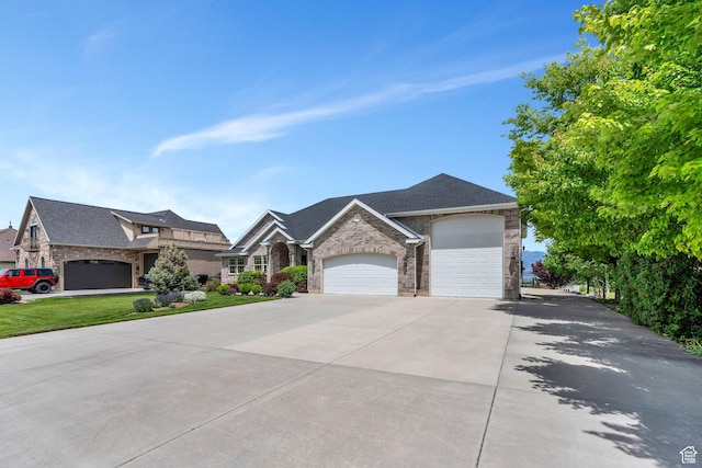 1736 S Range Rd, Saratoga Springs, UT 84045 - view of front facade with stone siding, driveway, and an attached garage