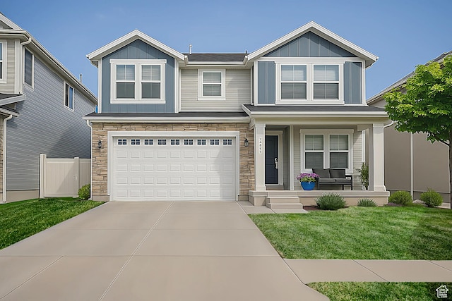 13211 S Weatherford Ln W, Herriman, UT 84096 - view of front of house featuring a porch, stone siding, board and batten siding, and concrete driveway