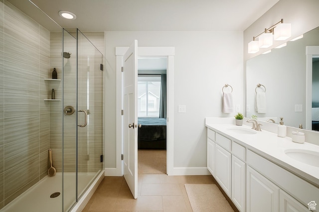 13211 S Weatherford Ln W, Herriman, UT 84096 - bathroom with ensuite bath, double vanity, tile patterned floors, a stall shower, and baseboards