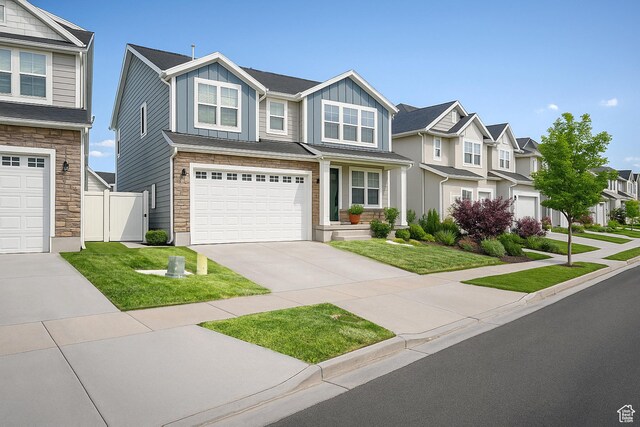 13211 S Weatherford Ln W, Herriman, UT 84096 - view of front of house with stone siding, board and batten siding, a residential view, driveway, and an attached garage