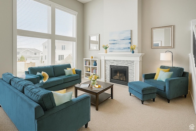 13211 S Weatherford Ln W, Herriman, UT 84096 - living area featuring light colored carpet, healthy amount of natural light, a tiled fireplace, a high ceiling, and baseboards