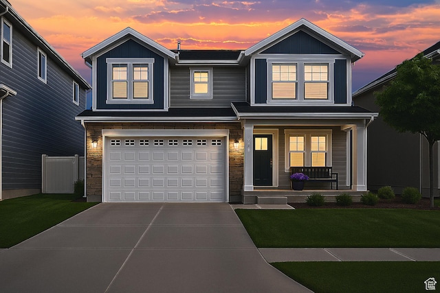 13211 S Weatherford Ln W, Herriman, UT 84096 - view of front of house with covered porch, stone siding, concrete driveway, and an attached garage