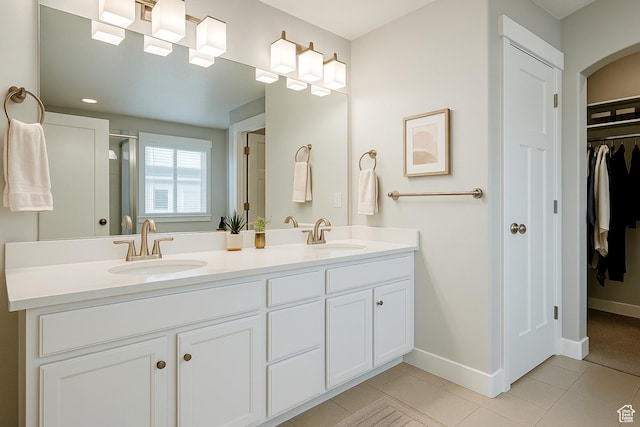 13211 S Weatherford Ln W, Herriman, UT 84096 - full bath featuring double vanity, a walk in closet, baseboards, tile patterned flooring, and a shower with shower door