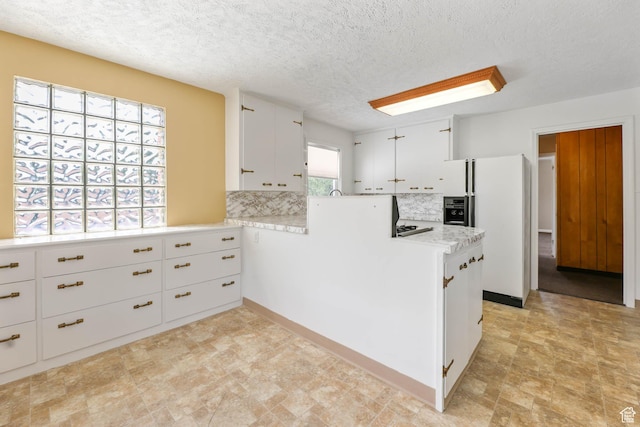 810 Canyon Rd, Ogden, UT 84404 - kitchen with white fridge with ice dispenser, backsplash, light countertops, white cabinetry, and a peninsula